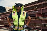 A person wearing PPE and standing with their hands on their hips