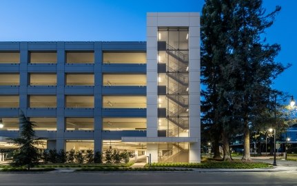 Exterior view of parking garage at night.