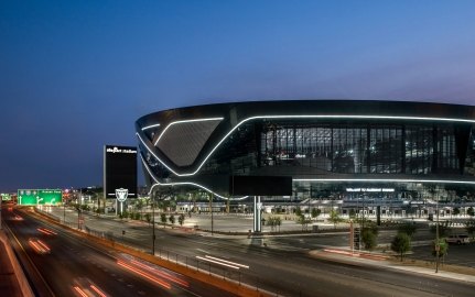 Aerial view of the stadium at night, with the highway in front