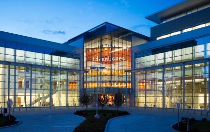 Looking into Edward Jones South Campus building windows at dusk