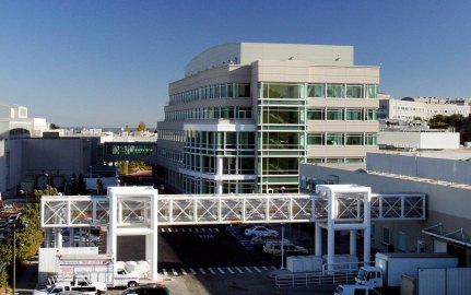 Exterior view of a building with a walkway in front. 