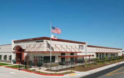 San Joaquin Regional Transit District Bus Maintenance, Fueling and Wash Station Exterior with US Flag