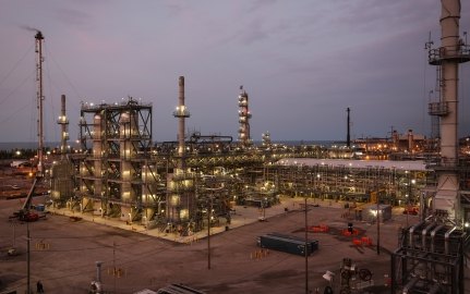 Outdoor image of the Oil Hydrotreater with lots of piping and lighting