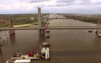 A crane on a barge in the water during construction