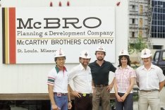 Construction workers standing in front of the McBro Brothers Sign.