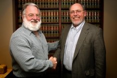 Mike McCarthy and Mike Bolen shaking hands.