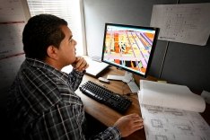 A person sitting at their desk working at a computer.