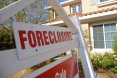 Foreclosure sign in front of a house.