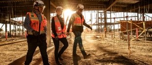 3 construction workers walking on a jobsite