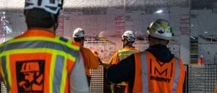 workers at a scrum meeting