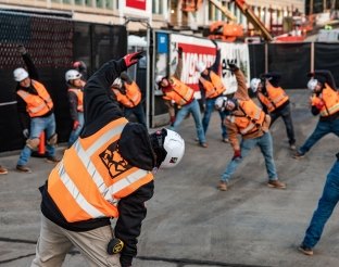 Construction workers stretching. 