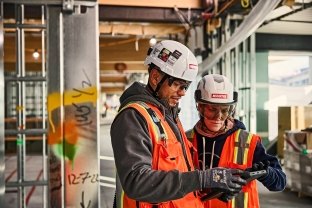 Two people collaborating on a jobsite.