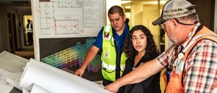 People looking over site plans.