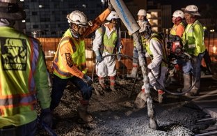 Group of people working on pouring concrete