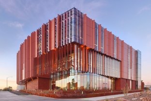 Exterior view of the red-colored University of Arizona Applied Research Building.