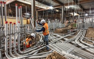 Two people working on plumbing