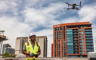 A person operating a drone that's in the air