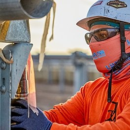 A person looking at an electrical component of a renewable energy project