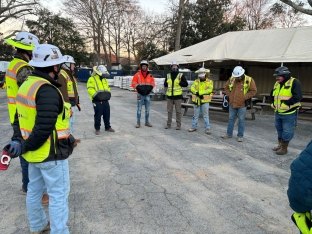 Team-huddle-at-Rockdale-Courthouse-jobsite