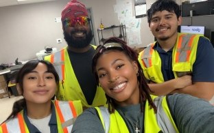A group of four people posing for a selfie
