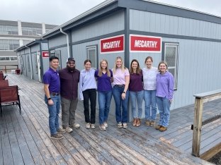 Group of McCarthy partners wearing purple in honor International Women's Day