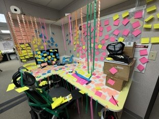 A sticky note prank at a desk