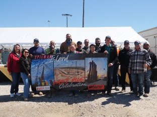 A group of people posing with a sign