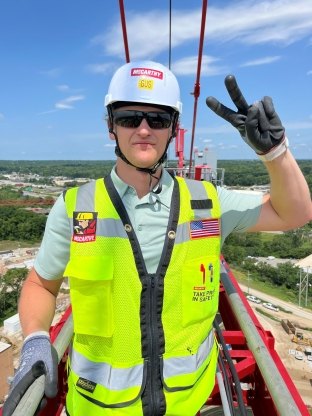 A person wearing PPE and posing for a photo