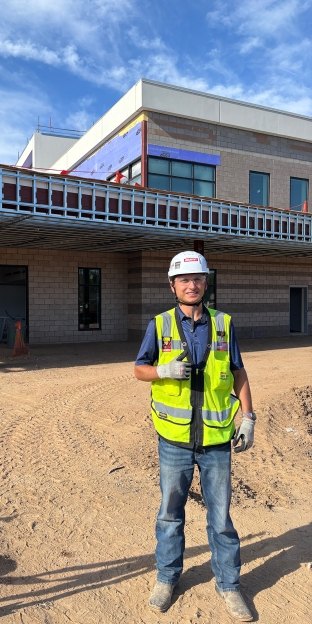 A person wearing PPE standing on a jobsite