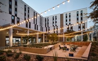 Outdoor seating area next to the student housing building