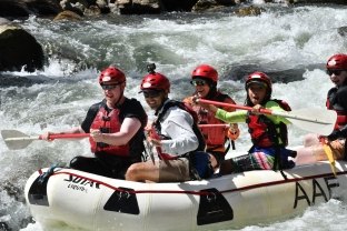 A group of people whitewater rafting