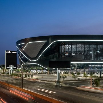 Aerial view of the stadium at night, with the highway in front