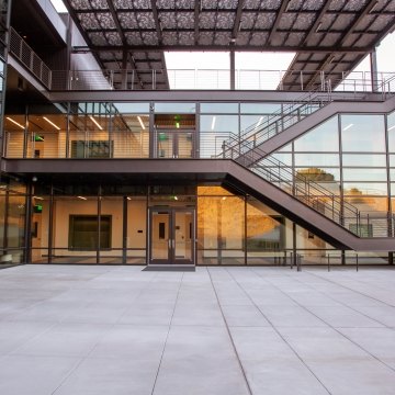 A staircase and large glass windows on the exterior of a building.