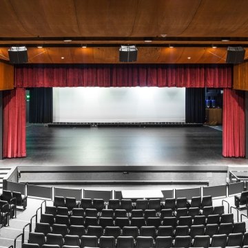 A performance hall with a stage and theater seating.