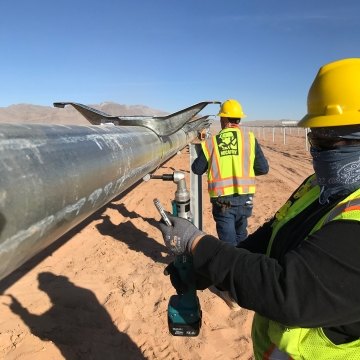 Solar workers tackle a metal installation at the Arrow Canyon Solar project to start 2022. 