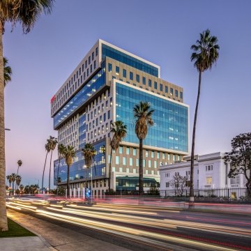 Sunset Bronson Studios ICON Office Tower with surrounding buildings, roadway and palm trees