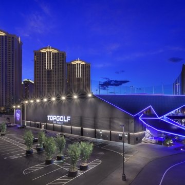 Exterior view of the Topgolf building at nighttime