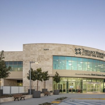 Entrance and front of the cancer structure that features a blue sky and trees