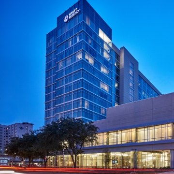 Outdoor image of the hotel with a medium blue sky