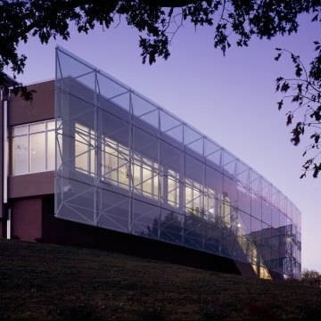 Outdoor image of the front of the building which is all glass