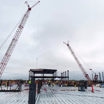 Two cranes tower of the Next NGA West facility under construction in St. Louis, Missouri.