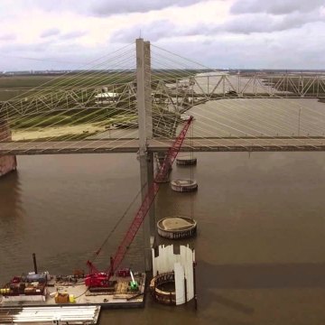 A crane on a barge in the water during construction