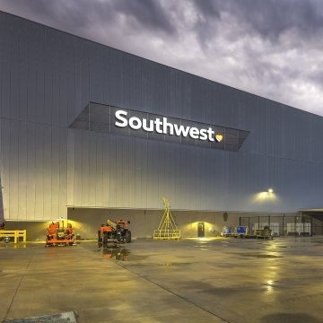 Exterior view of the hangar at nighttime with Southwest sign