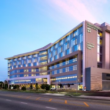 Outdoor image of the medical center with blue windows and a blue sky