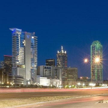 Exterior view of the hotel from the roadway at nighttime