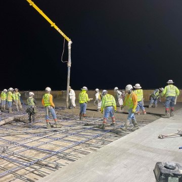 construction workers pouring concrete