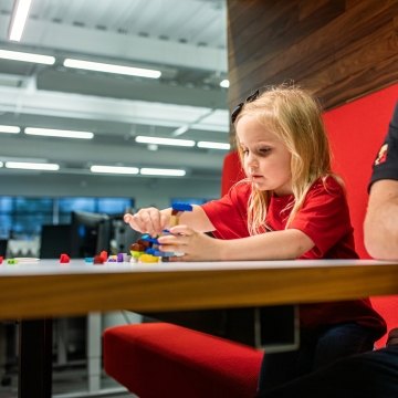 A child building with Legos at the table