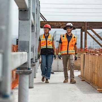 Two people walking a jobsite