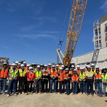 Group of people wearing PPE standing at a jobsite