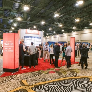 A group of people at McCarthy's DBIA booth in 2024. 